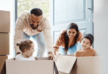 Family playing in moving boxes after a successful local moving with Callaghan's Moving Services Inc.