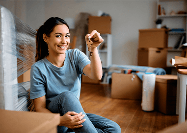 Person unpacking a box after a resdential move Family playing in moving boxes after a successful local moving with Callaghan's Moving Services Inc.